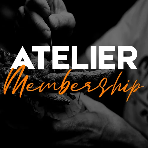 Hand holding a piece of paper with the words 'atelier membership' printed on it