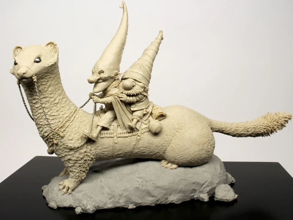 White sculpted miniature llama with two figures riding, set against a white background