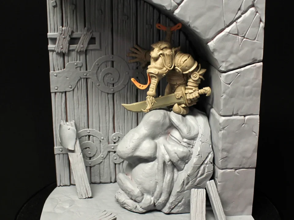 Miniature figurine of a man holding a sword, part of ‘Journeyman Miniatures’ by Paul Bonner, set against a gated wall