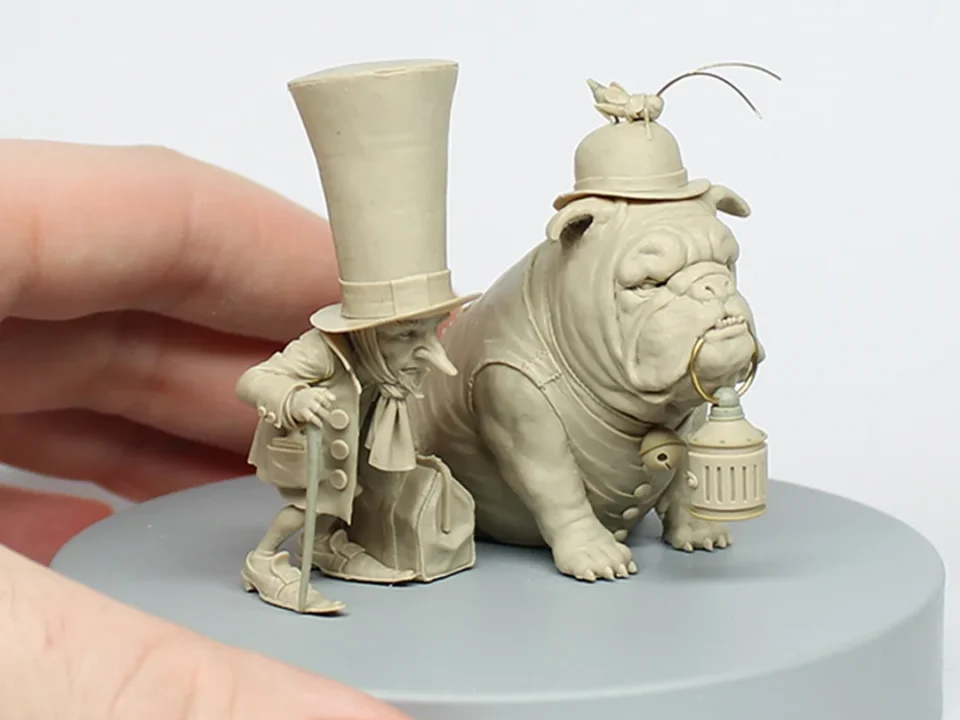 Hand-holding a bulldog top-hat sculpture by Jean-Baptiste Mange, titled 'Blacksmith Miniatures'