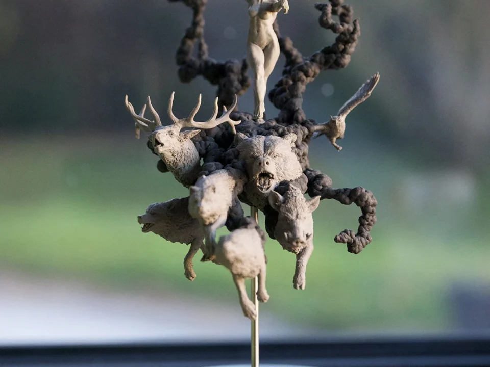 Bronze sculpture of stylized figures on a table