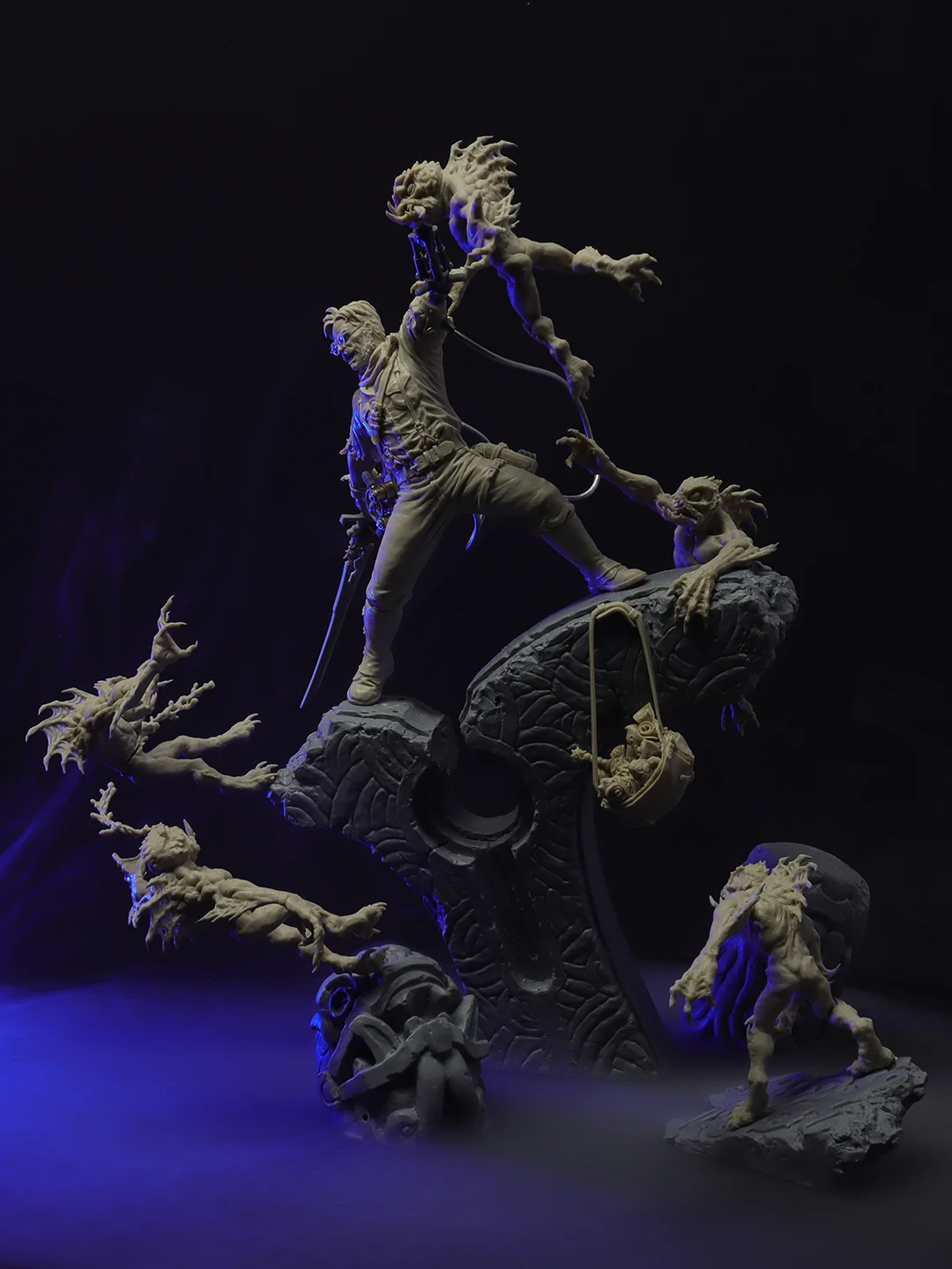 Intricate demonic statue with spread wings and raised head, surrounded by people in dark robes